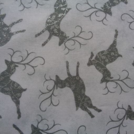 grey and silver leaping reindeer on white cotton