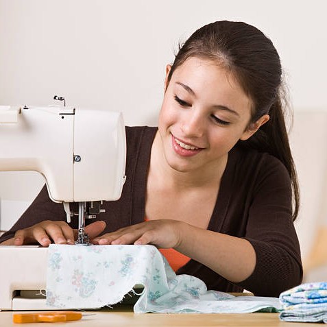 image of girl using a sewing machine