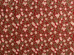 mini pink-bell shaped flowers and white daises with green foliage on a red ground