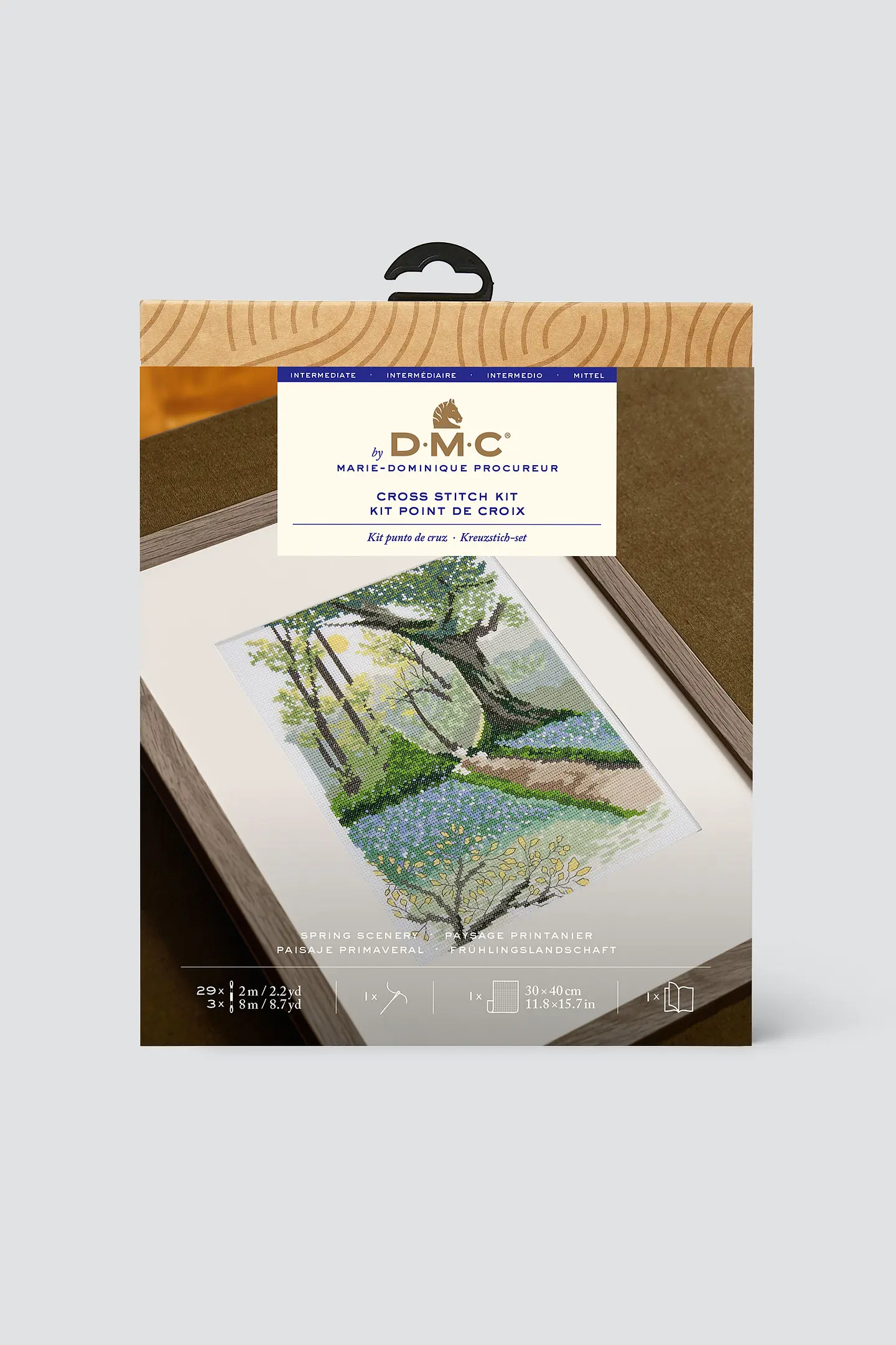 Package for DMC cross stitch kit showing scene of woodland in spring