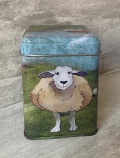 one side of tin showing a felted sheep